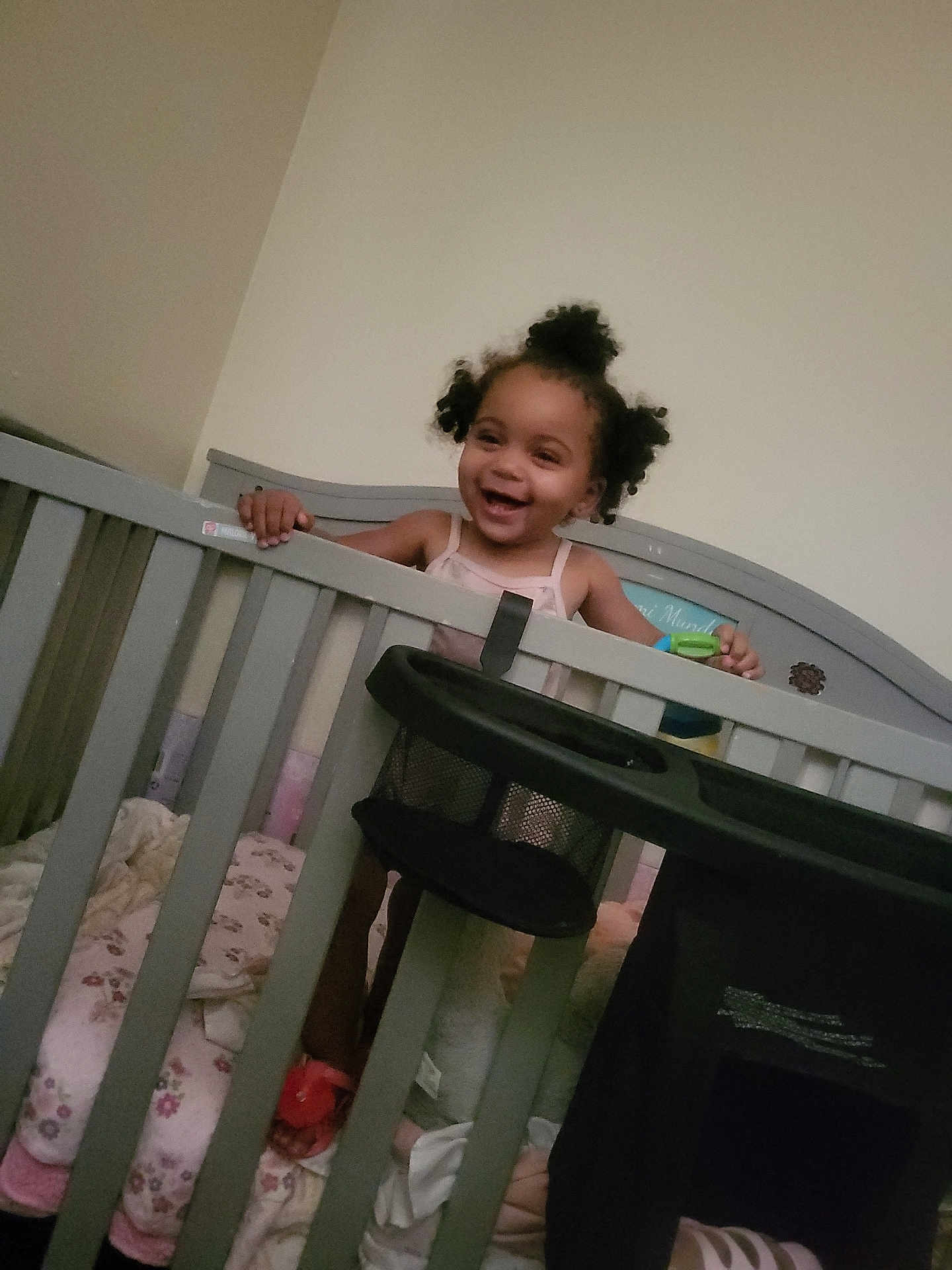 A'Zyriah is registered to the contest to win money with this photo: toddler, child, crib, baby, smiling, happy, indoor, bedroom, blanket, furniture, hair, person, infant, sleeping_area, toy, playful, grip, cute, home, young_child