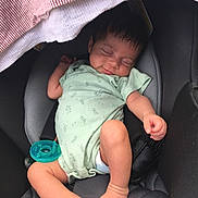 Ayzel is registered to the contest to win money with this photo: baby, sleeping, car_seat, onesie, pacifier, infant, child, cute, peaceful, soft_lighting, striped_cloth, foot, hand, indoors, closeup, person, newborn, comfort, resting, portrait