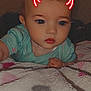 Raelynn is registered to the contest to win money with this photo: baby, infant, lying_down, blanket, patterned_blanket, face, digital_filter, devil_horns, cute, child, indoors, portrait, clothing, short_hair, skin, young_child, expressionless, soft_texture, close_up, human
