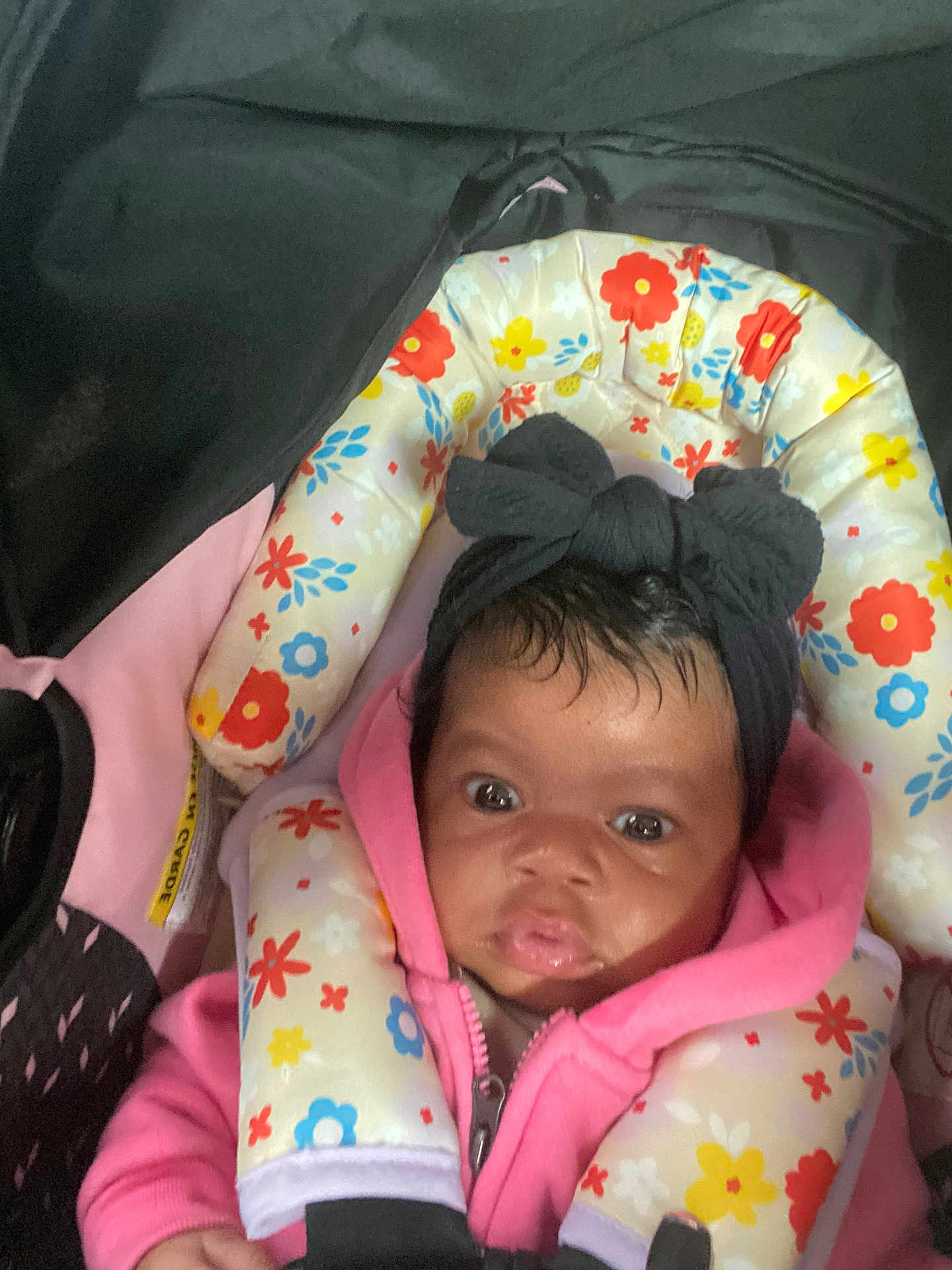 Amoura Mays joined the competition — help win amazing prizes! baby, infant, car_seat, headband, pink_hoodie, floral_pattern, child, face, eyes, clothing, seatbelt, cute, indoors, person, young_child, headwear, expression, closeup, sitting, bundle