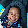 baby, smiling, car_seat, child, infant, harness, space_theme, rocket, planet, happy, cute, clothing, closeup, seat, child_safety, infant_seat, portrait, baby_face, baby_clothes, baby_accessory