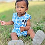 child, toddler, outdoor, grass, blue_clothing, mickey_mouse, sitting, nature, person, cute, summer, shoes, playing, daylight, casual, young_child, leaf, holding, curious, greenery