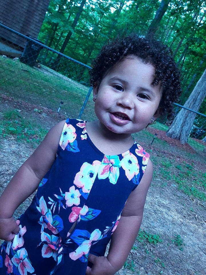 Kyra joined the competition — help win amazing prizes! baby_toddler_clothing, child, day_dress, dress, electric_blue, eye, facial_expression, fun, grass, happy, leaf, leisure, magenta, people_in_nature, person, plant, skin, smile, sunlight, toddler