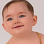 Elsie is registered to the contest to win money with this photo: baby, close_up, portrait, smile, blue_eyes, soft_skin, mustard_outfit, child, face, innocence, happy, cute, head, person, young_child, studio, expression, light_background, human, eyelashes