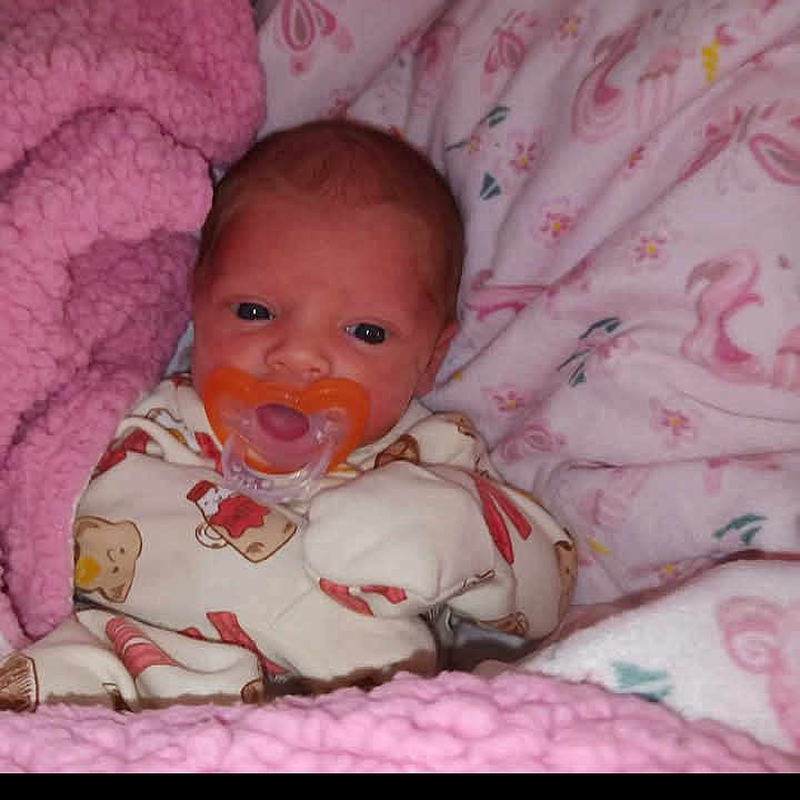 Nala joined the competition — help win amazing prizes! baby, bed, blanket, child, comfort, cozy, cute, face, indoor, infant, newborn, pacifier, pajamas, patterned, pink, resting, sleep, sleepwear, soft, warm