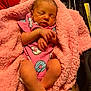 newborn, baby, sleeping, pink_blanket, onesie, donut_pattern, infant, cozy, cute, soft_texture, car_seat, stroller, peaceful, hands_crossed, indoor, clothing, portrait, child, resting, small