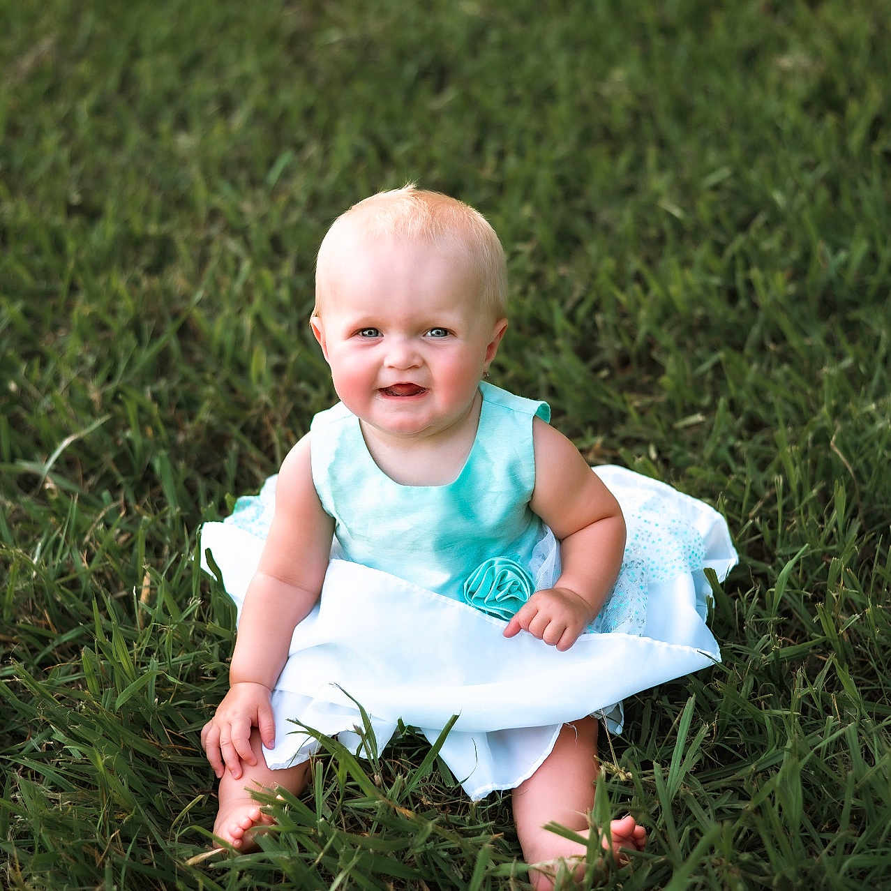 Isla joined the competition — help win amazing prizes! baby, barefoot, blue_dress, child, cute, dress, grass, greenery, happy, infant, nature, outdoor, person, playful, portrait, sitting, smile, summer, sunlight, young_child