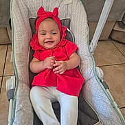 Hanna participe au concours pour gagner de l'argent avec cette photo : baby, infant, smile, red_clothing, headband, baby_seat, cushion, home_interior, tile_floor, happy, child, person, sitting, cute, playful, indoor, white_pants, fabric, comfort, portrait