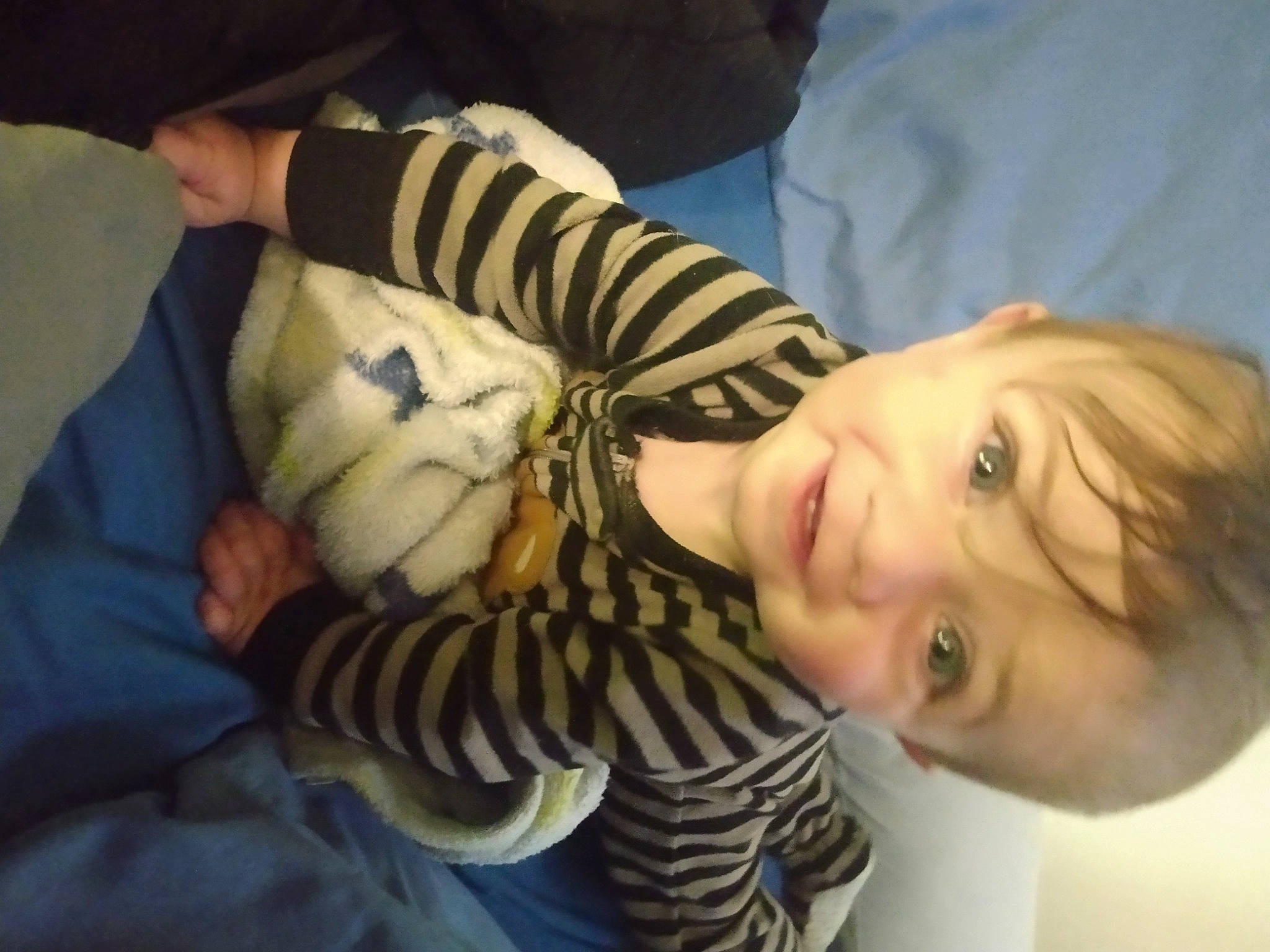 Earnest is registered to the contest to win money with this photo: baby, baby_toddler_clothing, cheek, child, comfort, cool, finger, happy, head, human_body, iris, linens, mouth, nose, pattern, person, skin, smile, toddler, tree