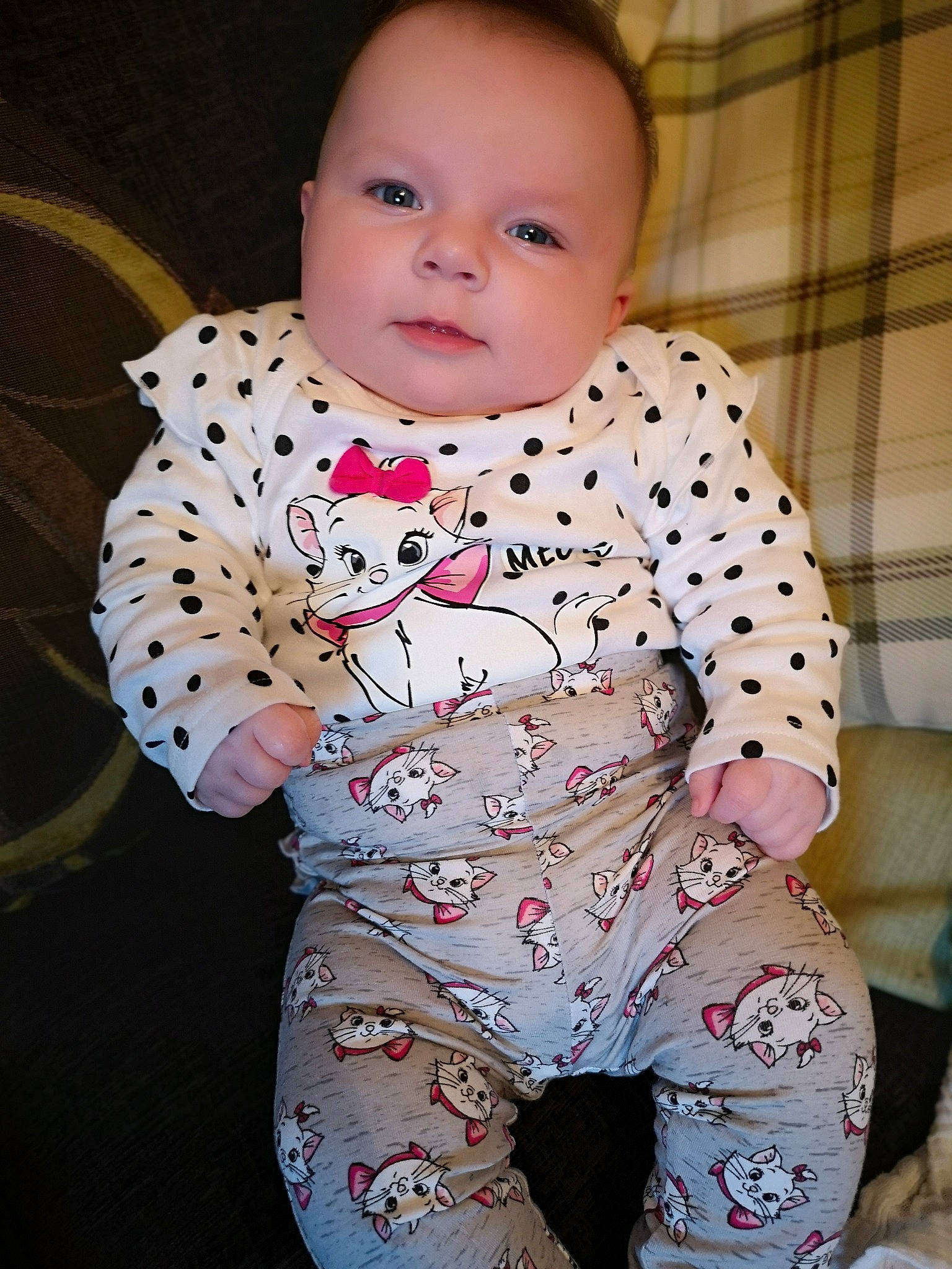 Harriet is registered to the contest to win money with this photo: baby, baby_products, baby_toddler_clothing, cheek, child, pajamas, person, pink, product, sitting, skin, sleeve, smile, toddler