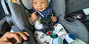 Semaj joined the competition — help win amazing prizes! automobile, baby, car_interior, car_seat, child, child_seat, cute, hand, happy, infant, inside, pajamas, person, safety_harness, seatbelt, smiling, socks, toddler, vehicle, young_child