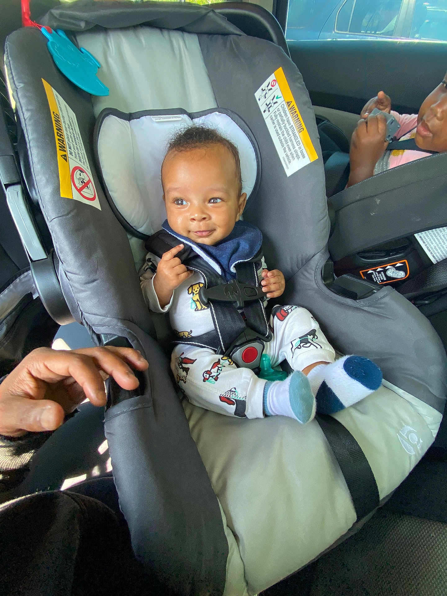 Semaj joined the competition — help win amazing prizes! baby, car_seat, child, toddler, car_interior, seatbelt, pajamas, smiling, socks, infant, hand, person, vehicle, safety_harness, cute, child_seat, automobile, young_child, happy, inside