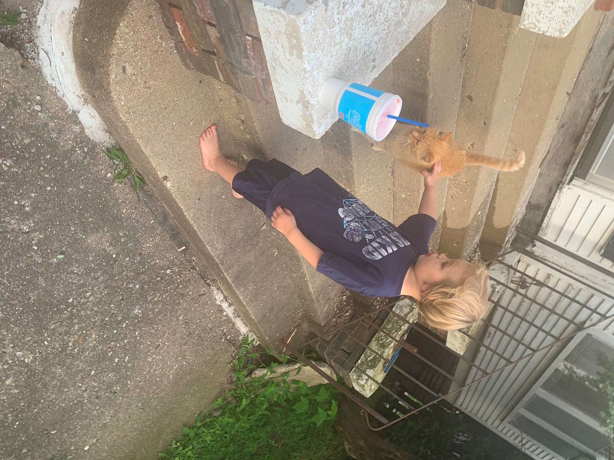 Tyson is registered to the contest to win money with this photo: asphalt, cement, composite_material, concrete, fun, grass, human_leg, leisure, person, plant, shadow, t_shirt