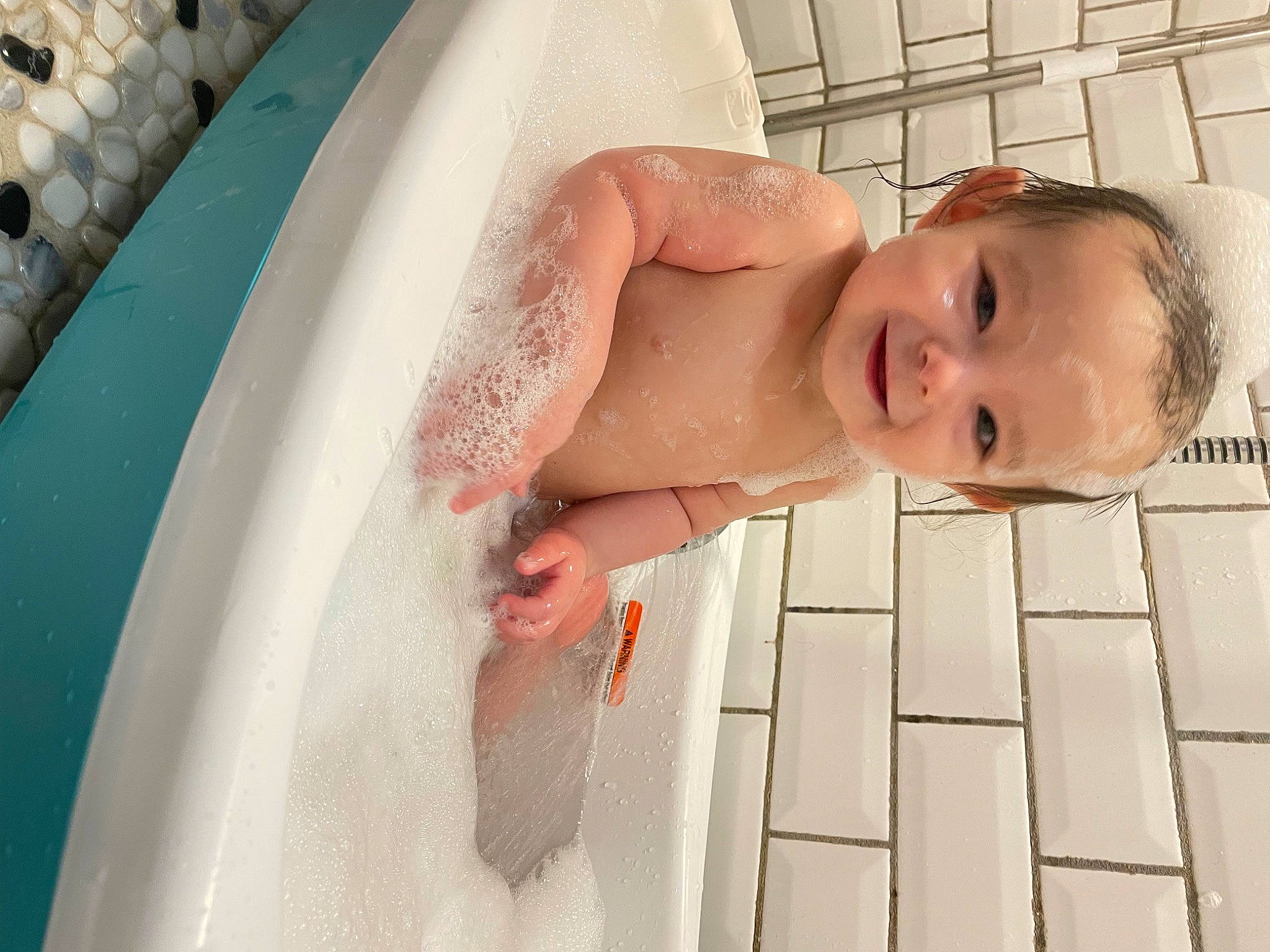 William is registered to the contest to win money with this photo: baby, baby_products, bathing, bathroom, chest, child, comfort, flooring, fun, happy, human_body, joy, leisure, person, plumbing, plumbing_fixture, room, skin, swimming_pool, toddler