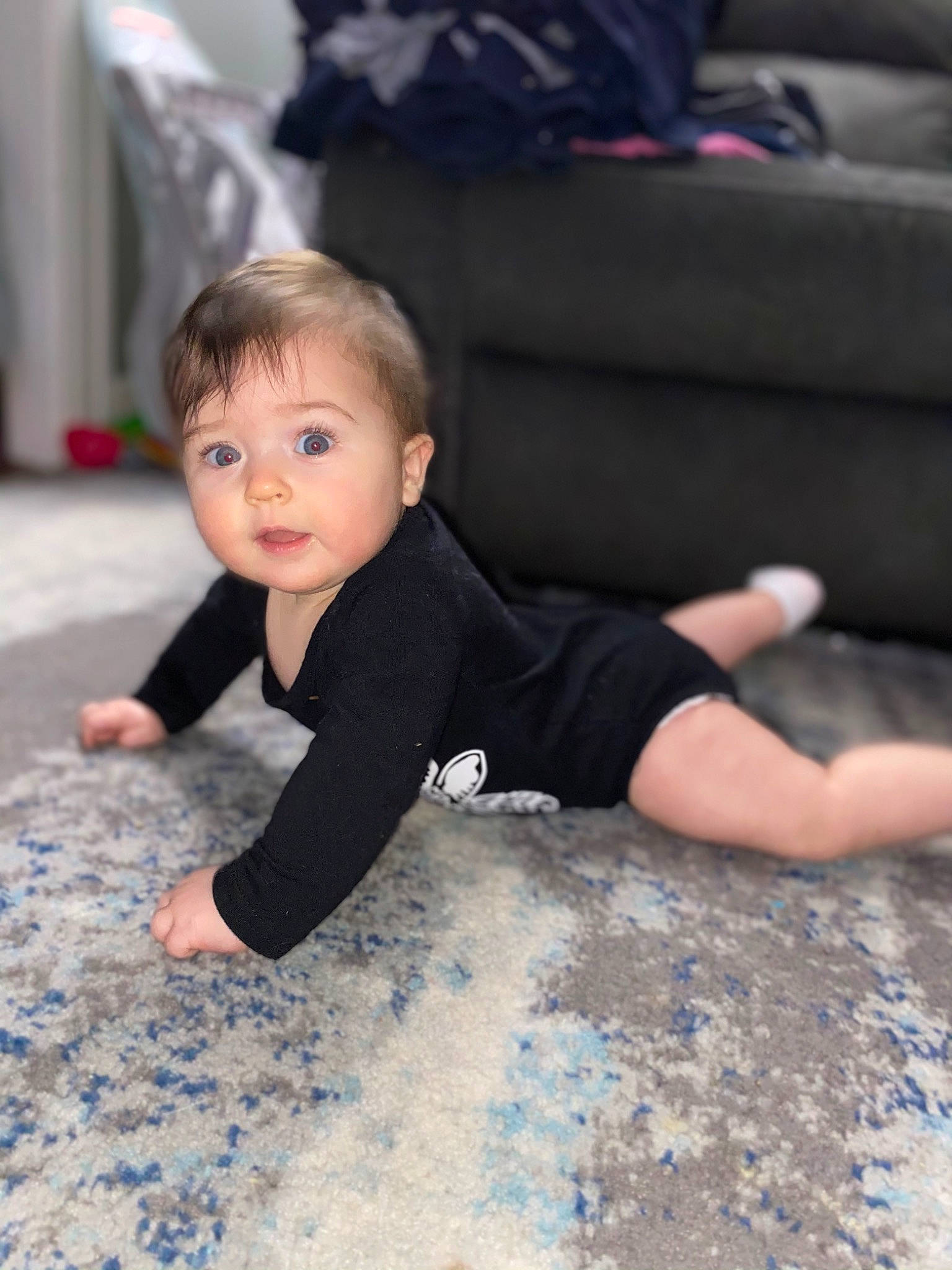Sofia is registered to the contest to win money with this photo: baby_crawling, baby_toddler_clothing, barefoot, child, comfort, couch, crawling, ear, elbow, finger, floor, flooring, foot, human_body, knee, living_room, mouth, person, sitting, toddler