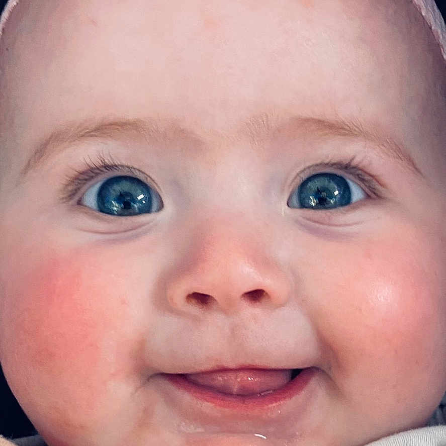 Aubrey is registered to the contest to win money with this photo: accessories, baby, baseballcap, bodypart, bonnet, cap, clothing, coat, face, finger, hand, happy, hat, head, jacket, newborn, person, photography, portrait, smile