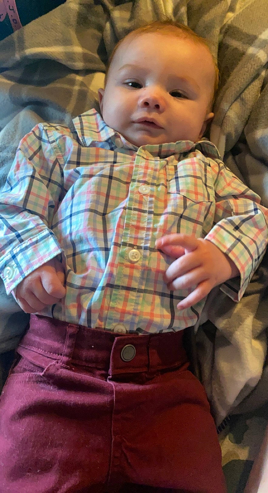 Elliot is registered to the contest to win money with this photo: arm, baby_toddler_clothing, cheek, chin, dress_shirt, eye, face, facial_expression, hairstyle, hand, head, joint, lip, nose, organ, person, plaid, skin, sleeve, standing