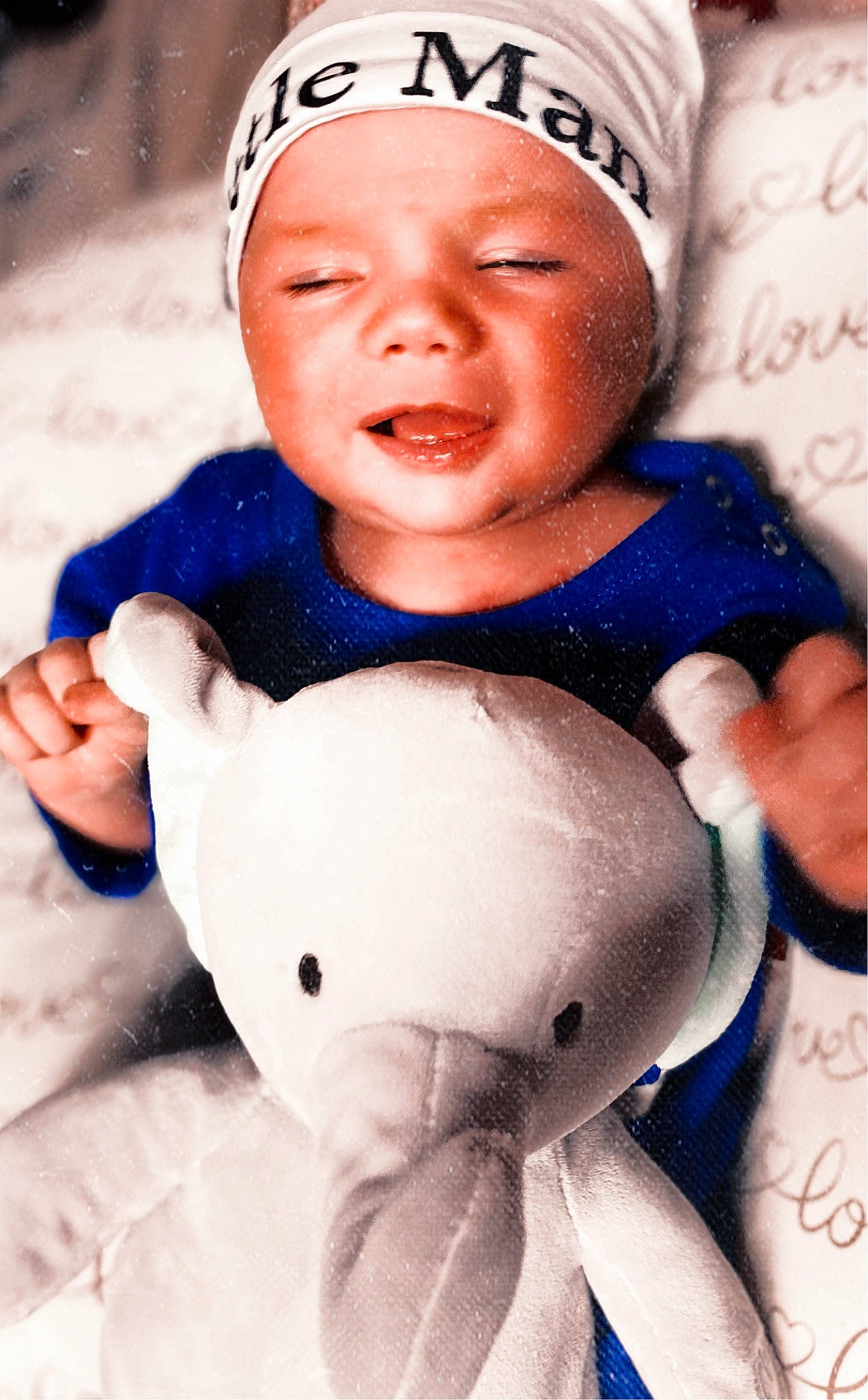 Elliot is registered to the contest to win money with this photo: baby, baby_products, baby_sleeping, cap, cheek, comfort, finger, gesture, happy, hat, headwear, human, mouth, nose, organ, person, pink, skin, thumb, toddler