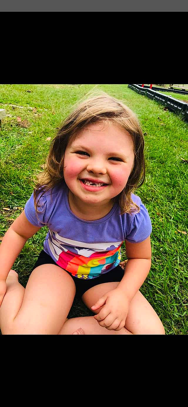 Mariella is registered to the contest to win money with this photo: blond, child, child_model, eye, face, facial_expression, fun, grass, happy, head, joy, laugh, person, photography, play, sitting, skin, smile, summer, toddler