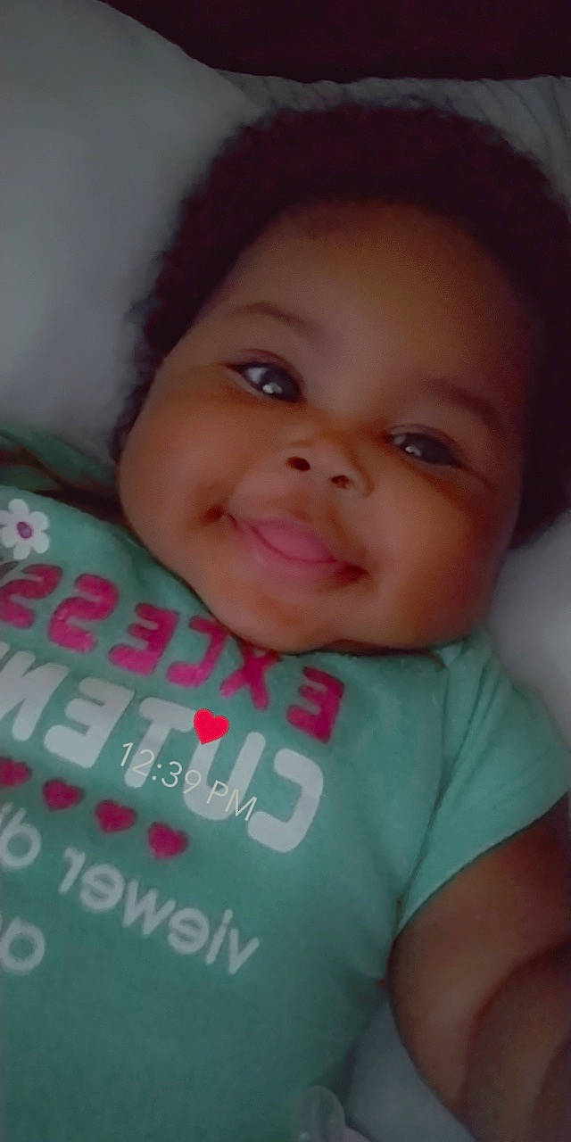 M'Lonie is registered to the contest to win money with this photo: cheek, chin, cool, eyebrow, eyelash, facial_expression, finger, forehead, happy, iris, joy, lip, mammal, mouth, neck, nose, organ, person, pink, skin