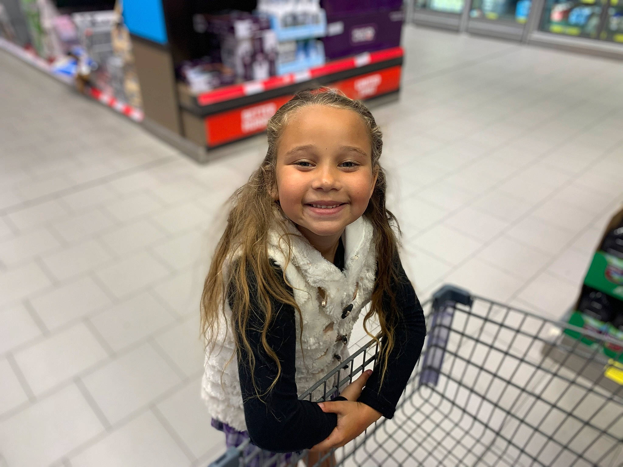 Ariah joined the competition — help win amazing prizes! child, convenience_store, customer, flooring, fun, happy, joy, leisure, person, recreation, retail, scarf, shelf, shopping, shopping_cart, sitting, smile, standing, street, toddler