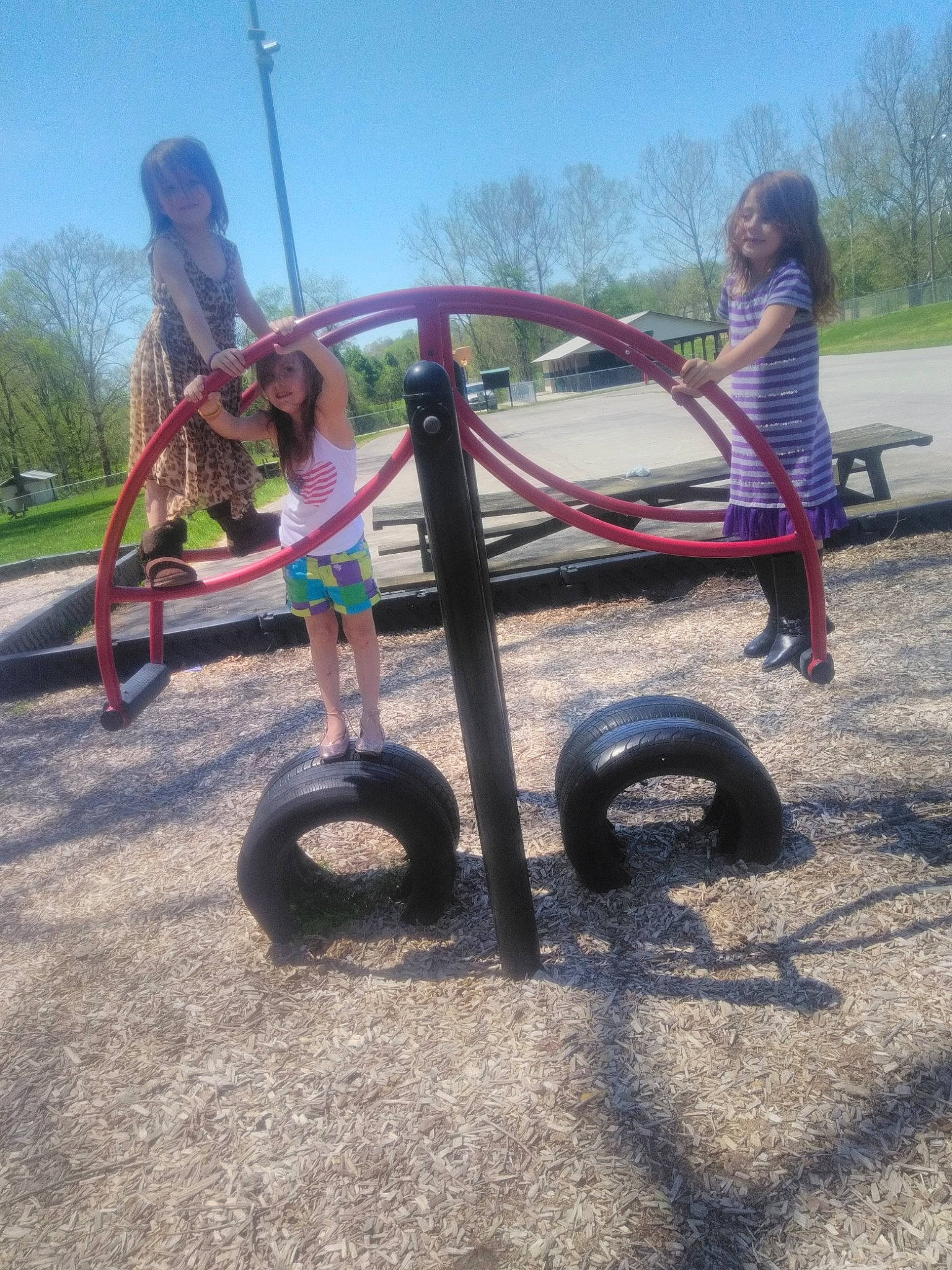 Jessica is registered to the contest to win money with this photo: child, city, fun, grass, human_settlement, joy, leisure, outdoor_play_equipment, park, person, plant, play, playground, public_space, recreation, swing, tree, vehicle