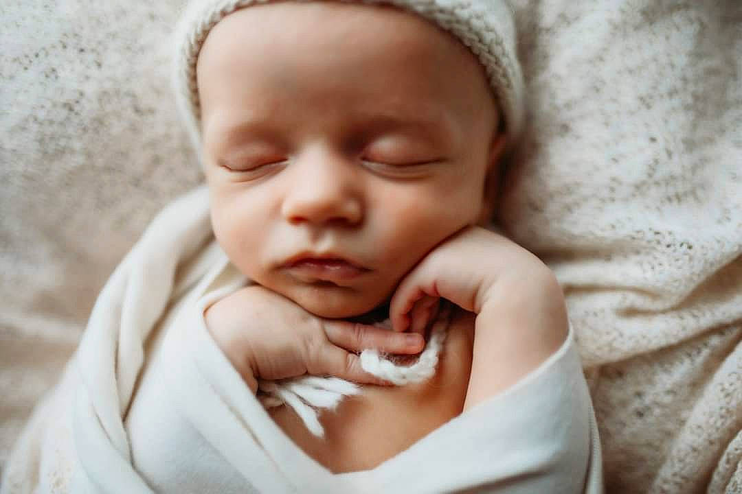 Dakota is registered to the contest to win money with this photo: baby, baby_sleeping, baby_toddler_clothing, cheek, child, close_up, comfort, eyebrow, gesture, hand, happy, linens, lip, mouth, nail, nose, person, skin, sleeve, thumb