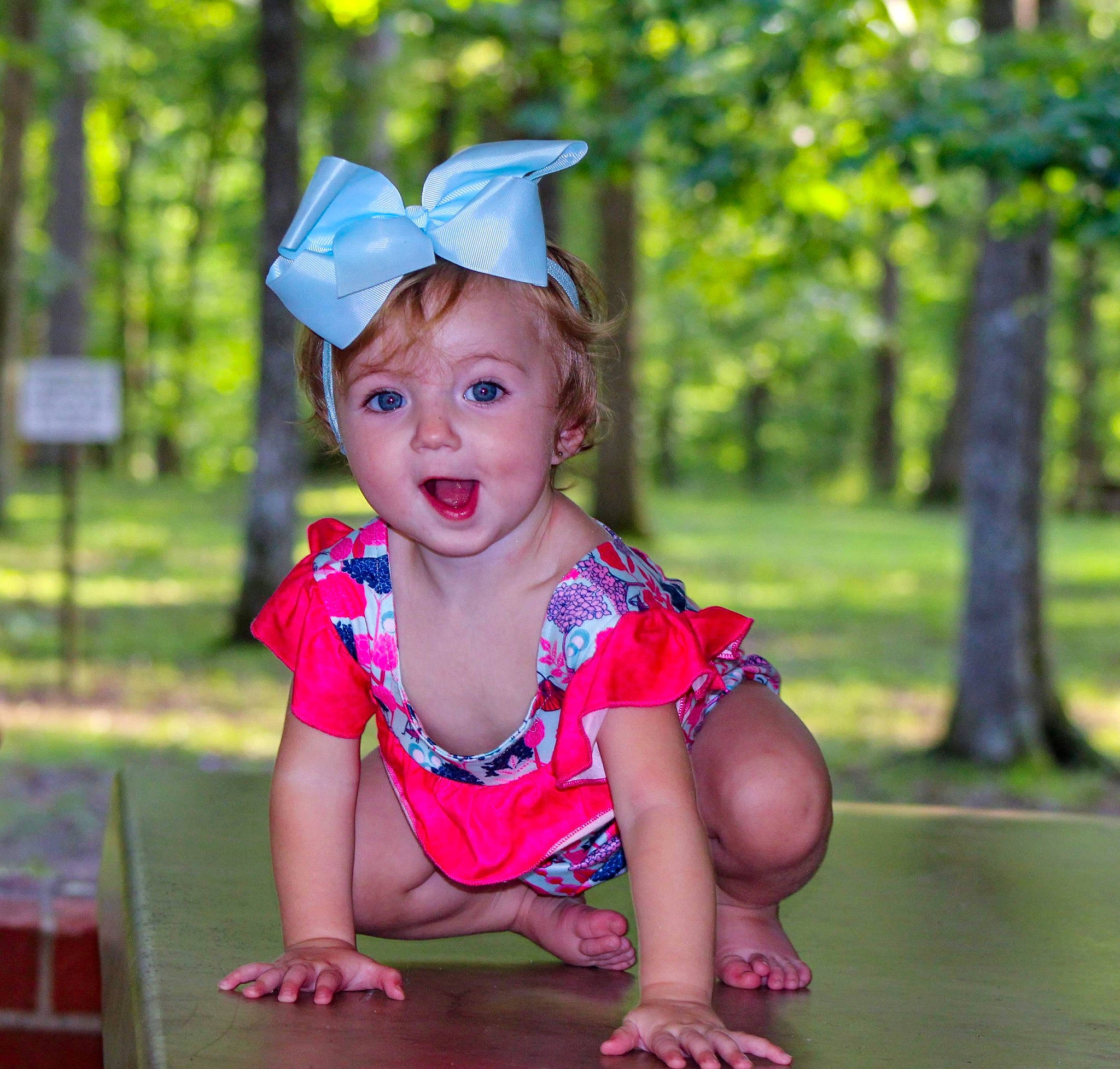 Mckinley is registered to the contest to win money with this photo: baby, baby_toddler_clothing, child, electric_blue, event, fashion_accessory, fun, grass, happy, hat, leisure, magenta, people_in_nature, person, pink, recreation, sitting, smile, summer, surprise