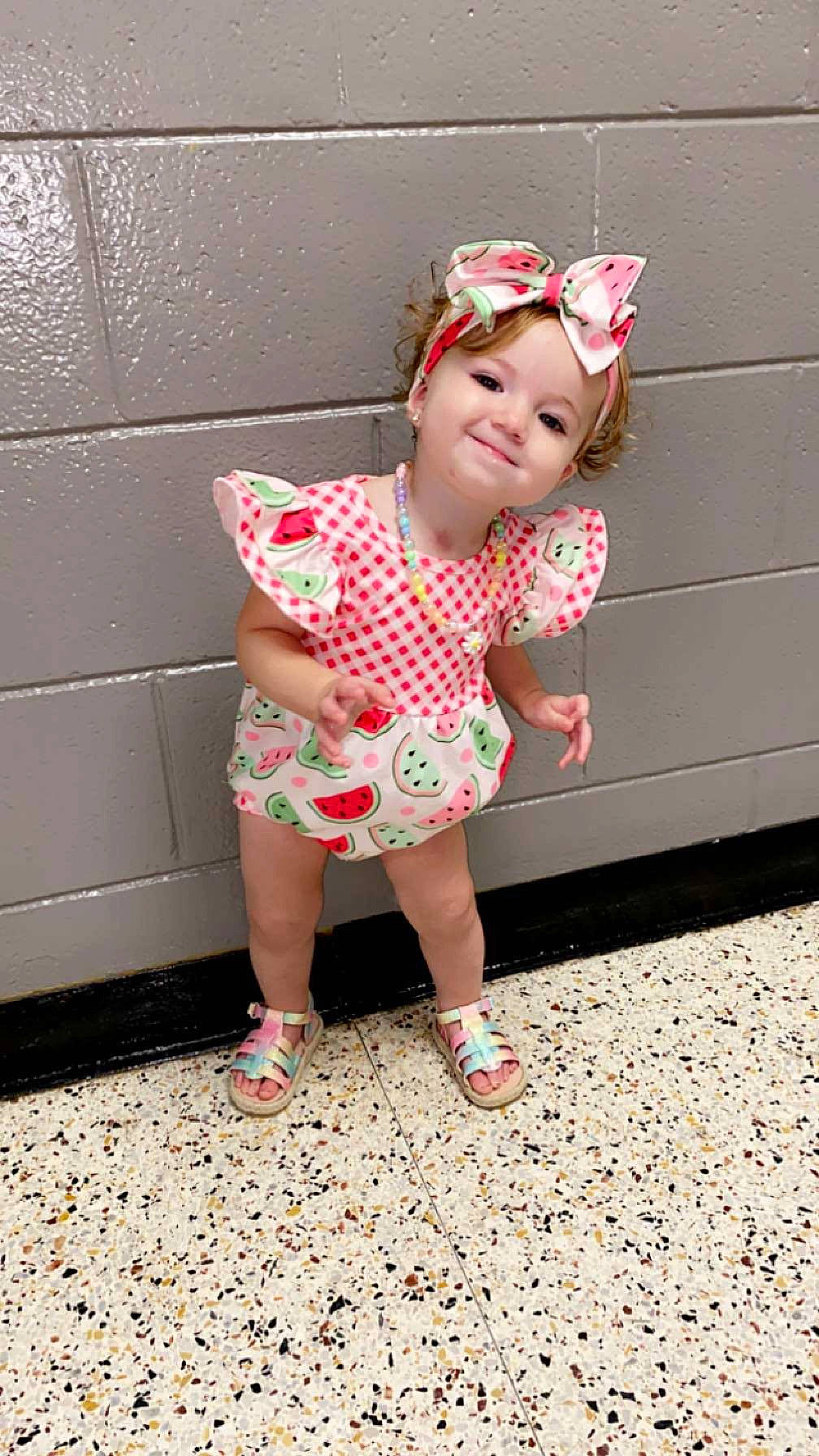 Mckinley joined the competition — help win amazing prizes! baby_toddler_clothing, child, fashion_accessory, foot, fun, grass, happy, hat, headwear, human_leg, joy, lip, magenta, pattern, person, photo_shoot, pink, play, sandal, sleeve