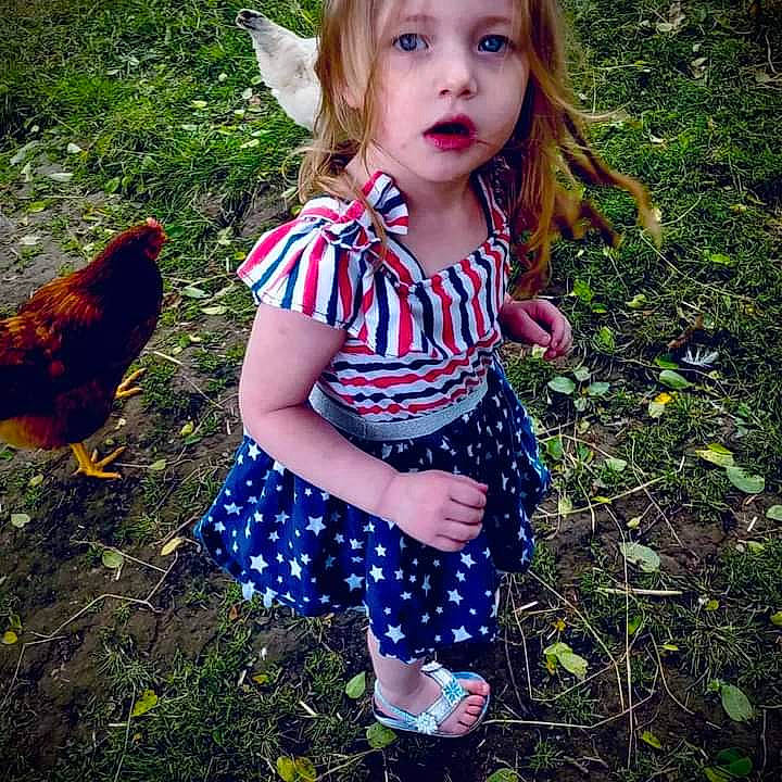 Rosalie is registered to the contest to win money with this photo: baby_toddler_clothing, beak, beauty, bird, botany, chicken, fawn, galliformes, grass, happy, leaf, pattern, people_in_nature, person, phasianidae, plant, poultry, summer, sunlight, t_shirt