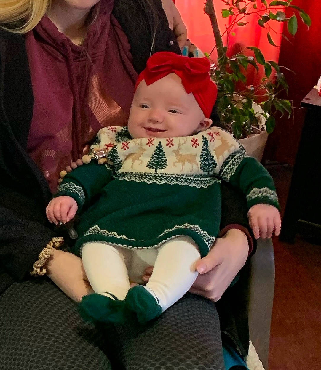 Faith is registered to the contest to win money with this photo: baby, baby_toddler_clothing, chair, child, costume_hat, event, fun, happy, hat, head, headwear, holiday, human_body, jewellery, joy, lap, person, plant, sitting, smile