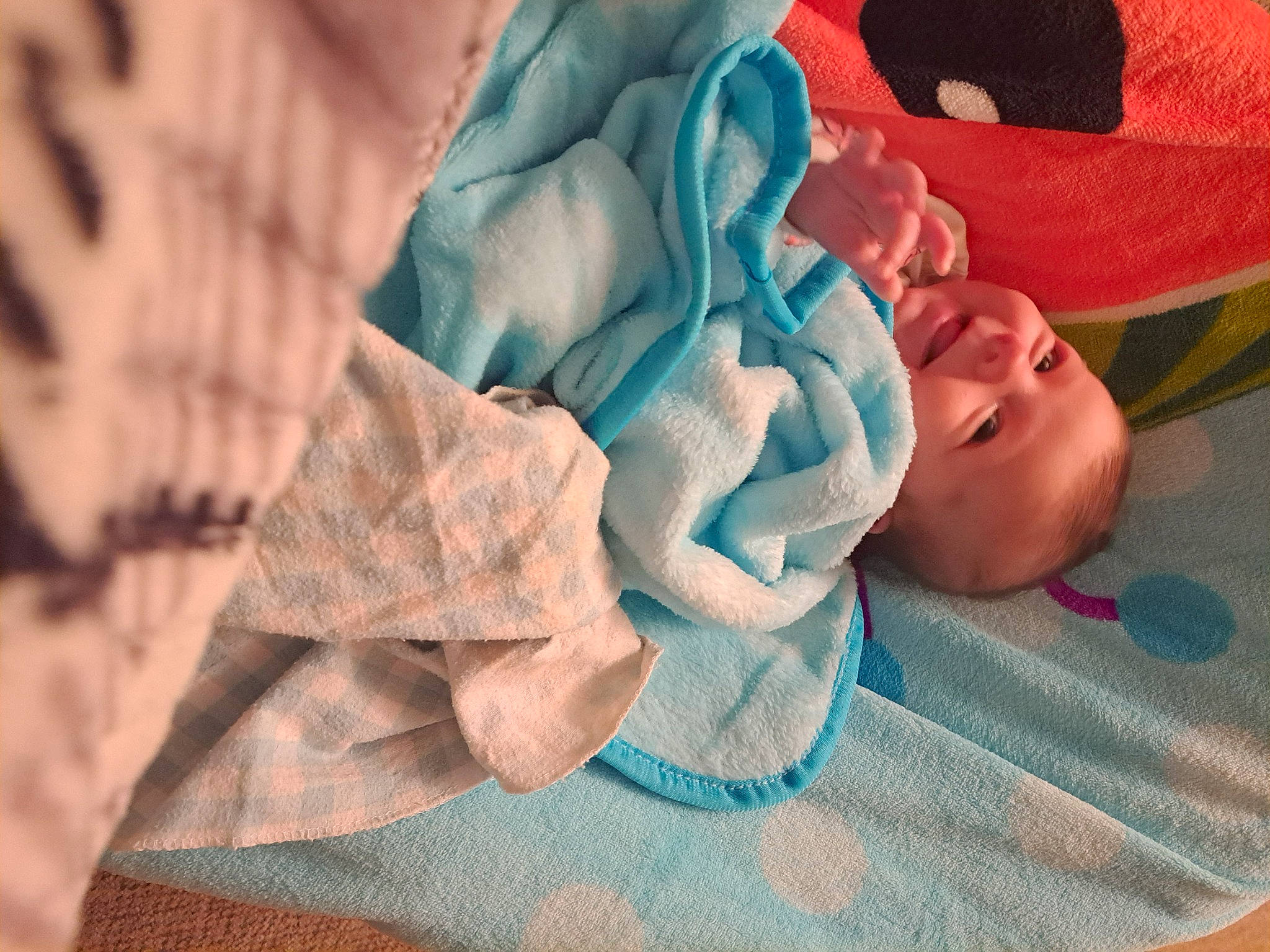 Noella is registered to the contest to win money with this photo: baby, baby_products, baby_toddler_clothing, bed_sheet, bedding, blanket, carmine, child, comfort, craft, electric_blue, fashion_accessory, linens, pattern, person, rose_order, smile, toddler, towel, wood