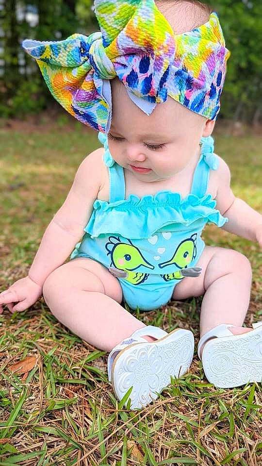 Brinley joined the competition — help win amazing prizes! baby, baby_toddler_clothing, blue, child, face, fun, grass, happy, headgear, headwear, leaf, pattern, people, people_in_nature, person, photograph, pink, plant, purple, summer