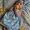 baby, barefoot, blanket, blue_dress, chewing, citrus, cozy, cute, daisy_pattern, eyes, fruit, hands, head, headband, infant, lemon, lying_down, nursery, portrait, soft_texture