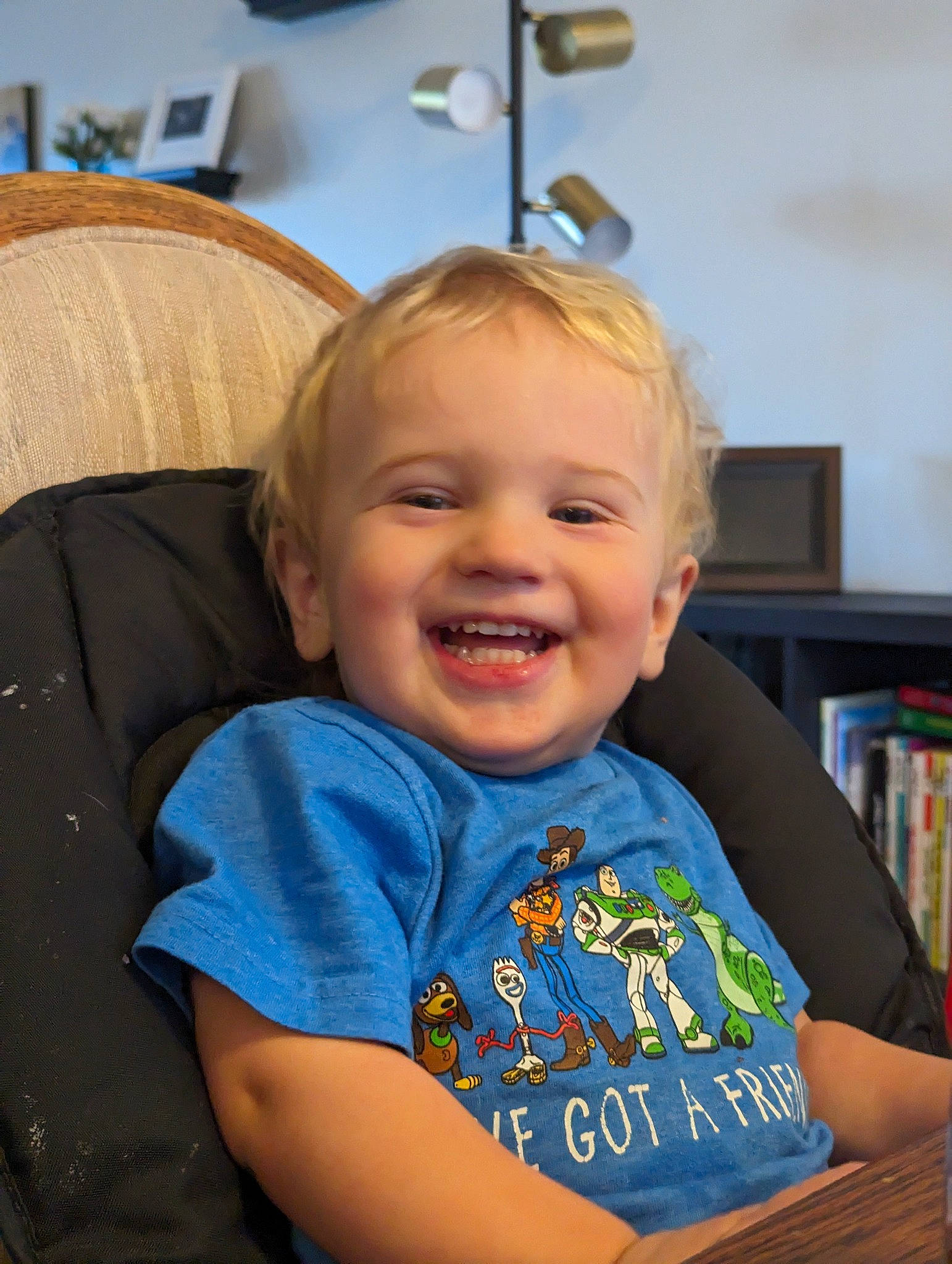 Axton joined the competition — help win amazing prizes! baby, baby_toddler_clothing, blond, bookcase, chair, cheek, child, chin, eye, fun, furniture, happy, iris, joy, person, shelf, skin, sleeve, smile, standing