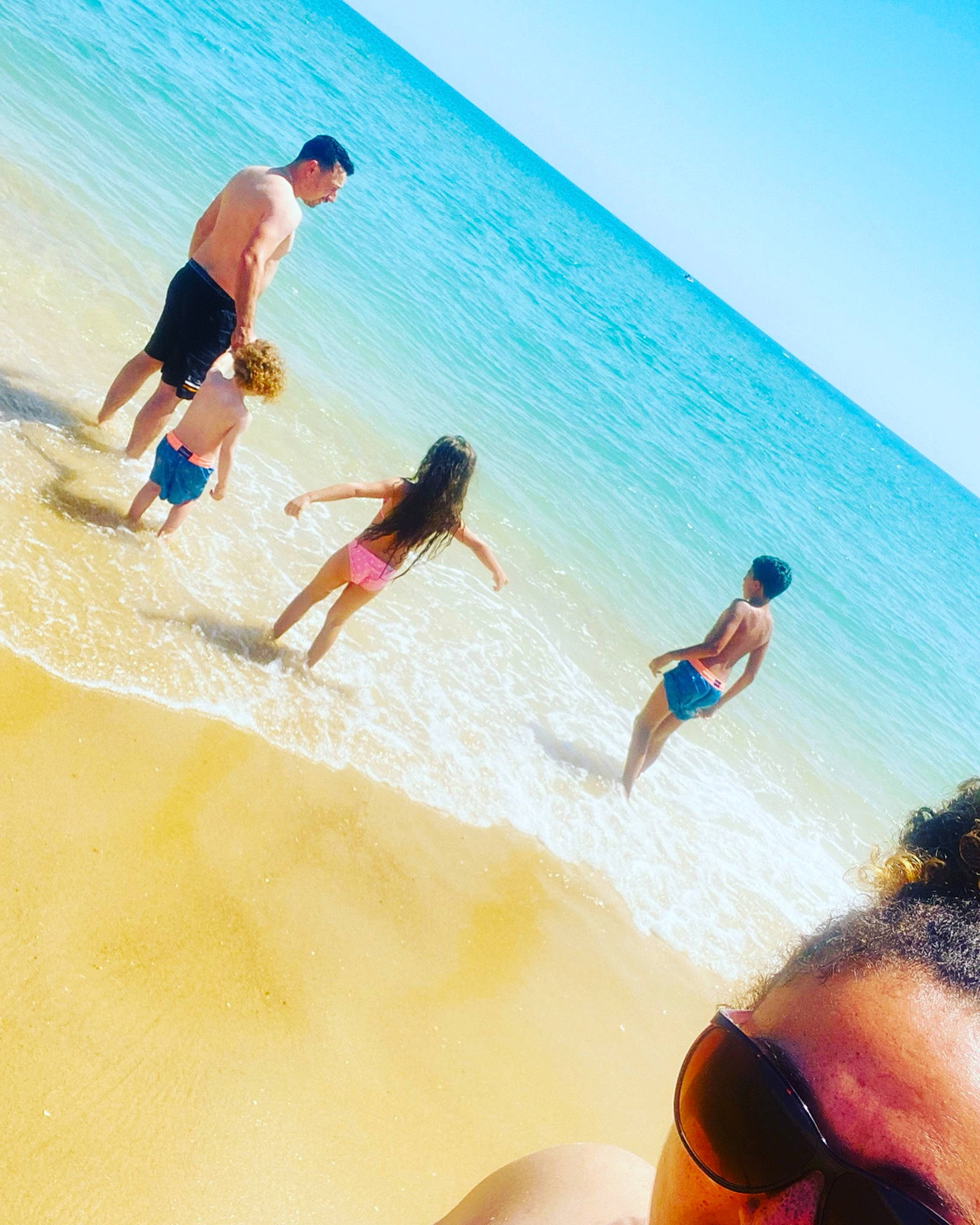 Wesley participe au concours pour gagner de l'argent avec cette photo : arm, beach, blue, coastal_and_oceanic_landforms, eyewear, happy, horizon, leisure, morning, people_in_nature, people_on_beach, person, sand, shorts, sky, summer, sunlight, swimwear, travel, water