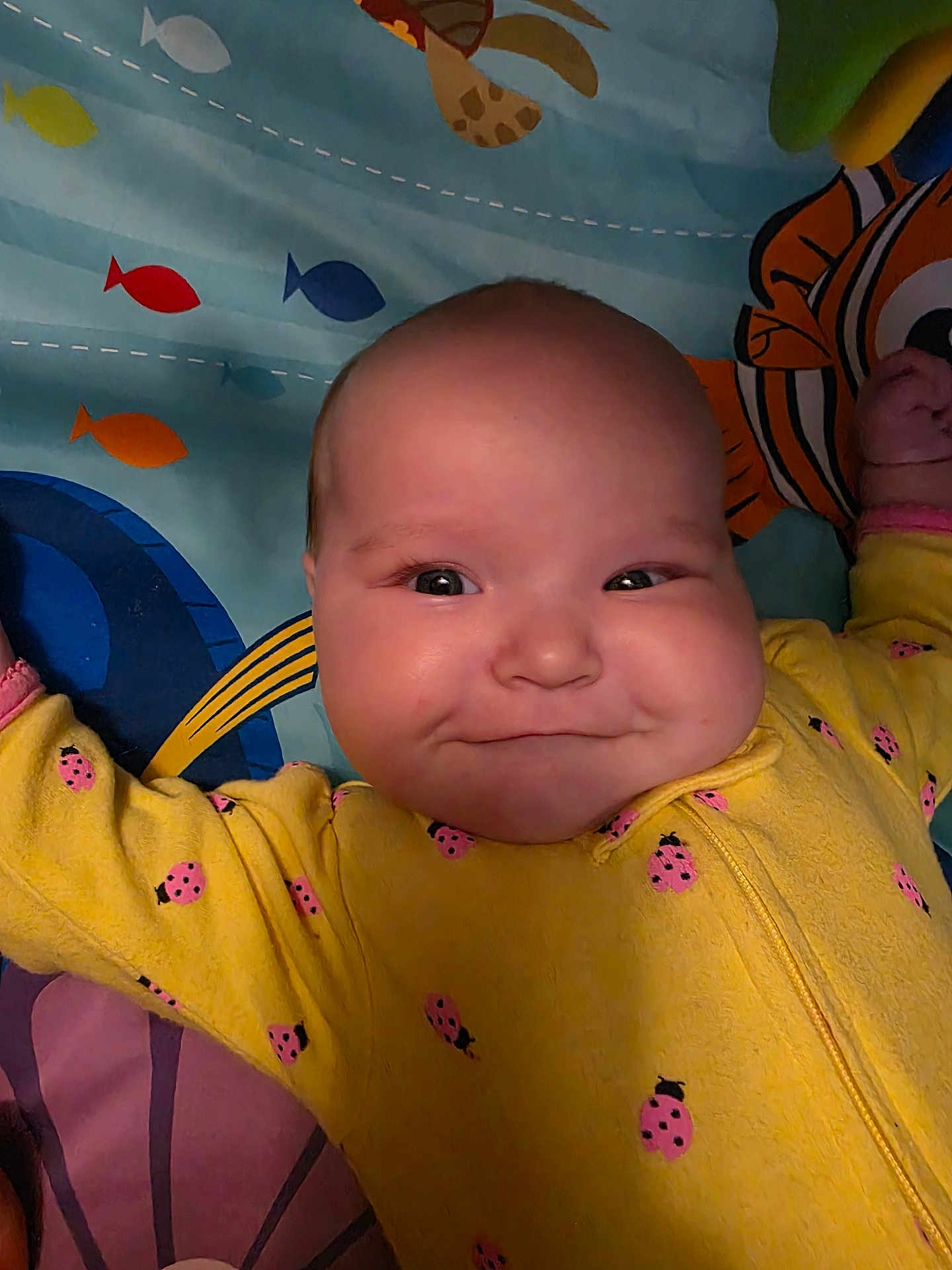 Elaina joined the competition — help win amazing prizes! baby, infant, smile, yellow_clothing, ladybug_pattern, face, cheeks, play_mat, fish_pattern, colorful, lying_down, arms_outstretched, child, cute, indoors, happy, portrait, skin, head, expression