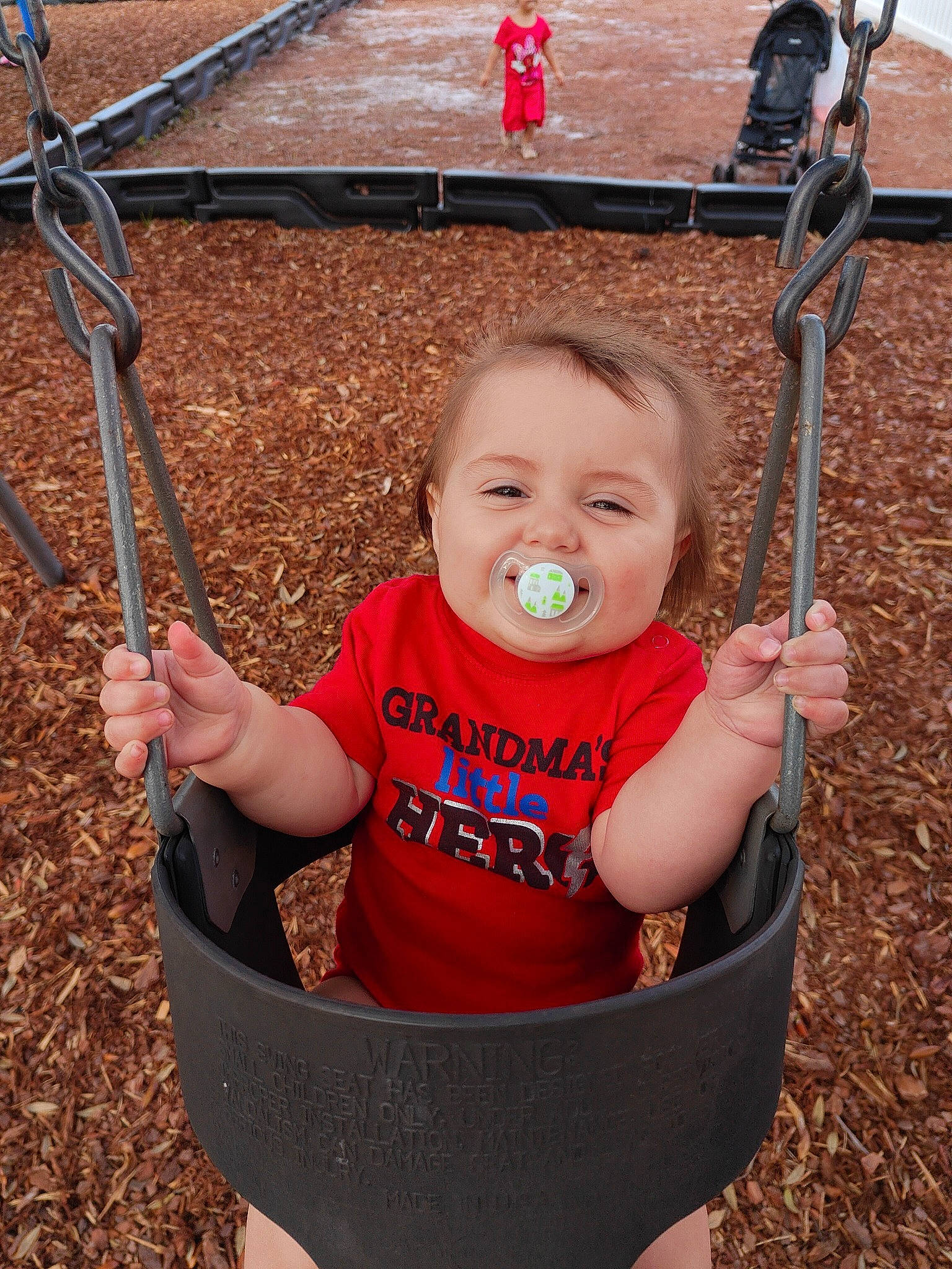 Sequoyah joined the competition — help win amazing prizes! baby, baby_toddler_clothing, beauty, cheek, chin, eye, facial_expression, fun, grass, happy, human_body, human_settlement, leisure, person, photograph, product, red, skin, snapshot, swing