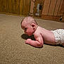 baby, diaper, carpet, floor, wood_paneling, room, infant, side_view, curious, indoors, child, skin, head, face, arm, person, crawling, young, casual, home