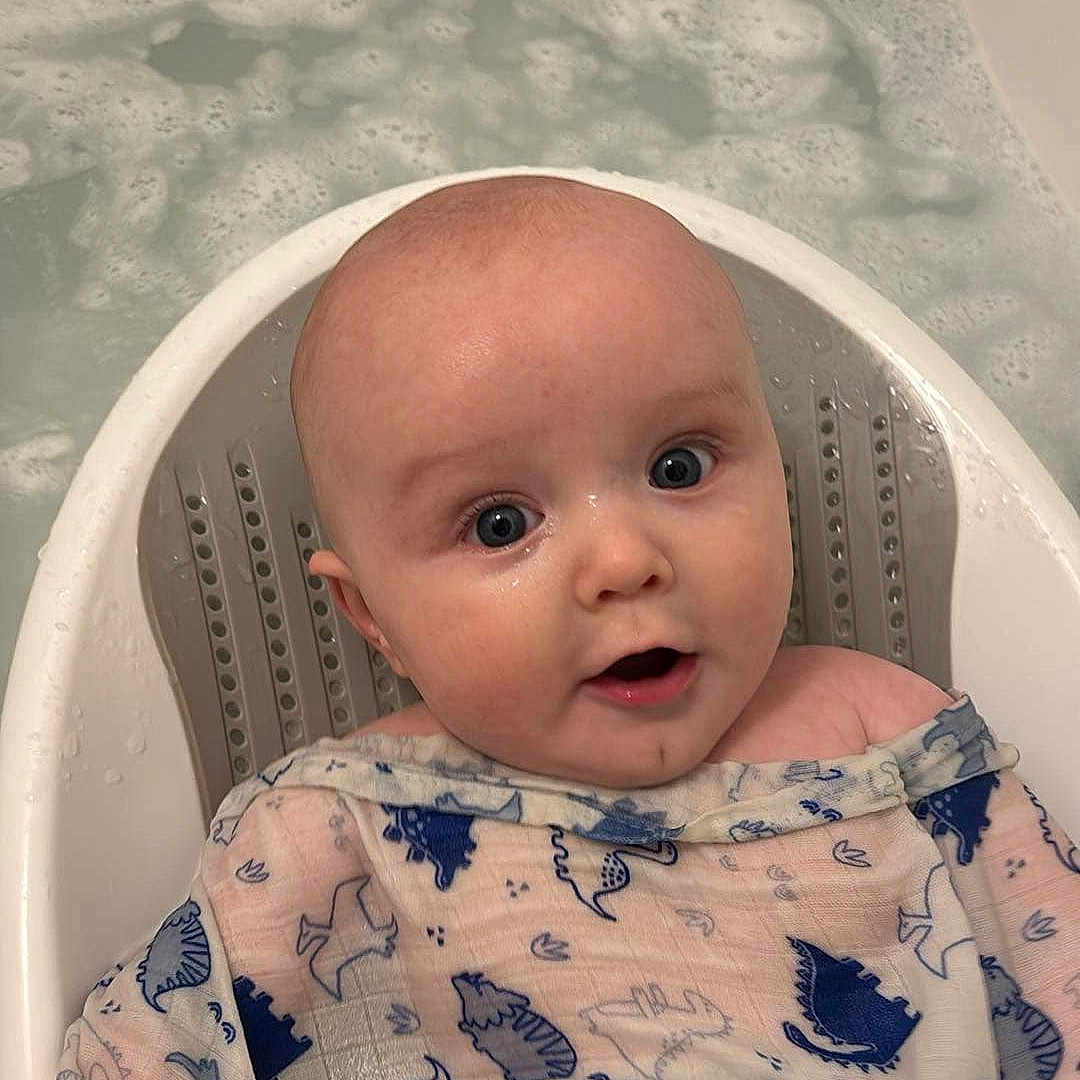 Reuben is registered to the contest to win money with this photo: baby, bathing, bathtub, bed, crib, face, furniture, happy, head, infantbed, leisureactivities, newborn, person, photography, portrait, skin, smile, sport, tattoo, tub