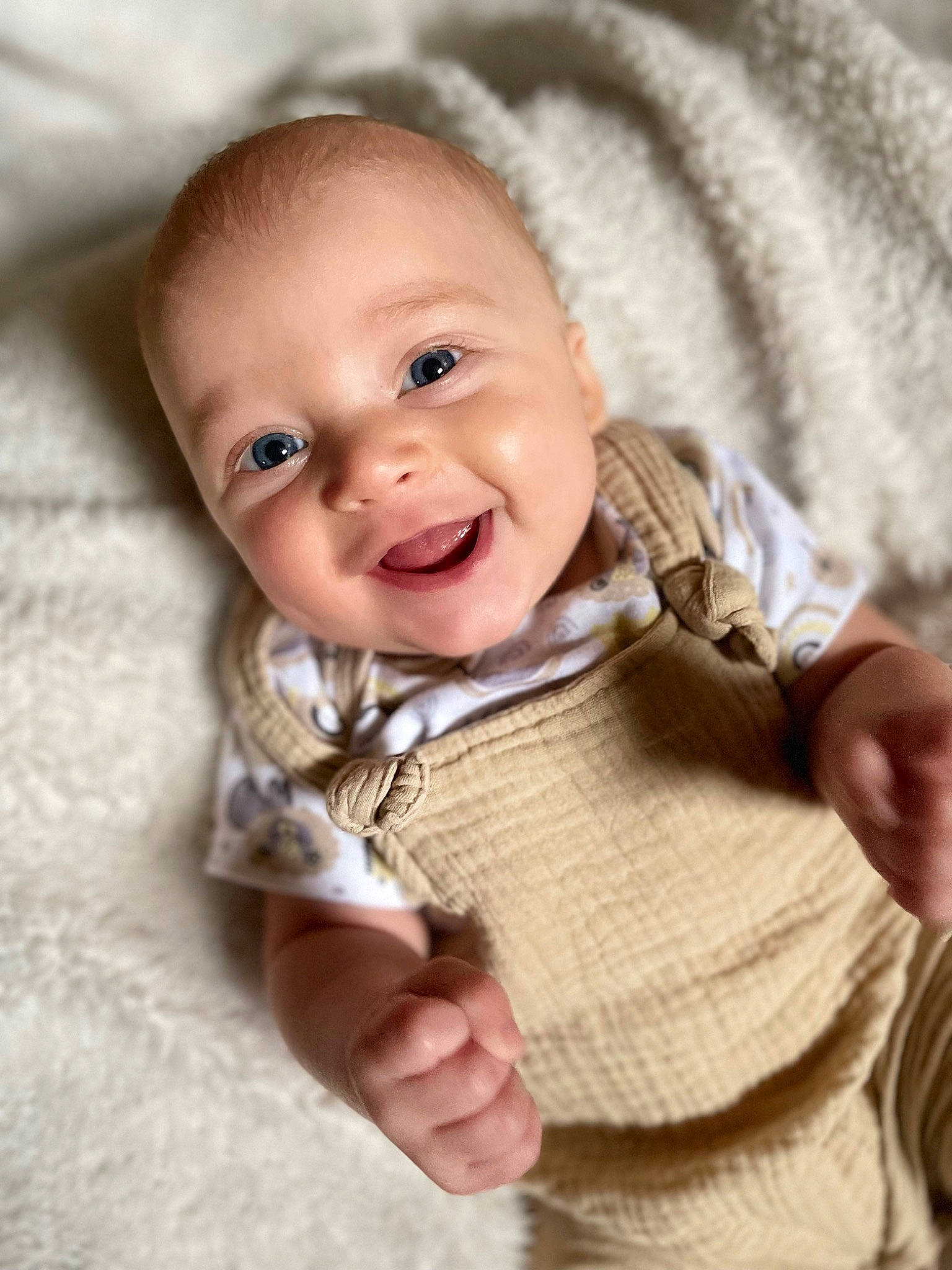 Kash is registered to the contest to win money with this photo: baby, baby_toddler_clothing, cheek, chin, collar, comfort, eye, gesture, happy, iris, linens, lip, nose, person, skin, sleeve, smile, textile, toddler, wood