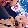 adult, arcade, baby, bib, bokeh, close_up, colorful_lights, face, filter_overlay, glasses, indoor, infant, onesie, pacifier, parent_child, playful, portrait, purple_ears, purple_glitter, selfie