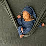 newborn, baby, sleeping, blue_clothing, hat, fabric, green, cozy, wrapped, peaceful, infant, cute, resting, soft_texture, portrait, child, tiny_feet, hands, indoor, comfortable