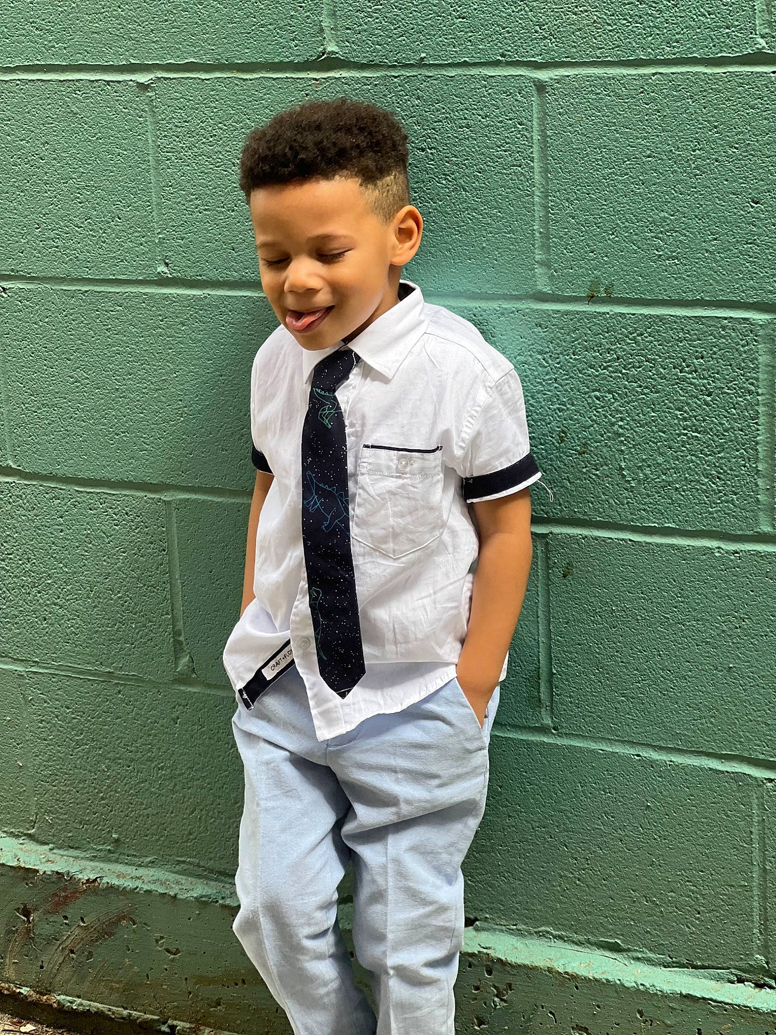 Jaquavon joined the competition — help win amazing prizes! blazer, brick, clothing, collar, cool, dress_shirt, electric_blue, formal_wear, gesture, hair, happy, neck, pattern, person, sleeve, smile, standing, street_fashion, toddler, waist