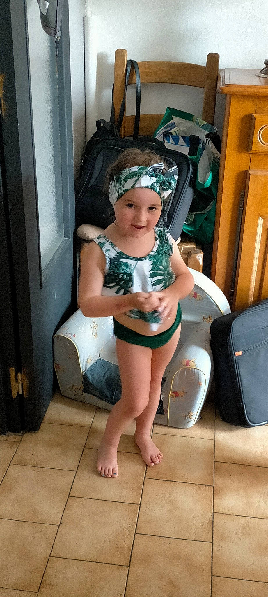 Rose participe au concours pour gagner de l'argent avec cette photo : abdomen, barefoot, chair, costume, diaper, flooring, foot, fun, hat, headwear, human_leg, knee, leisure, person, personal_protective_equipment, shorts, swimwear, thigh, toddler, trunk