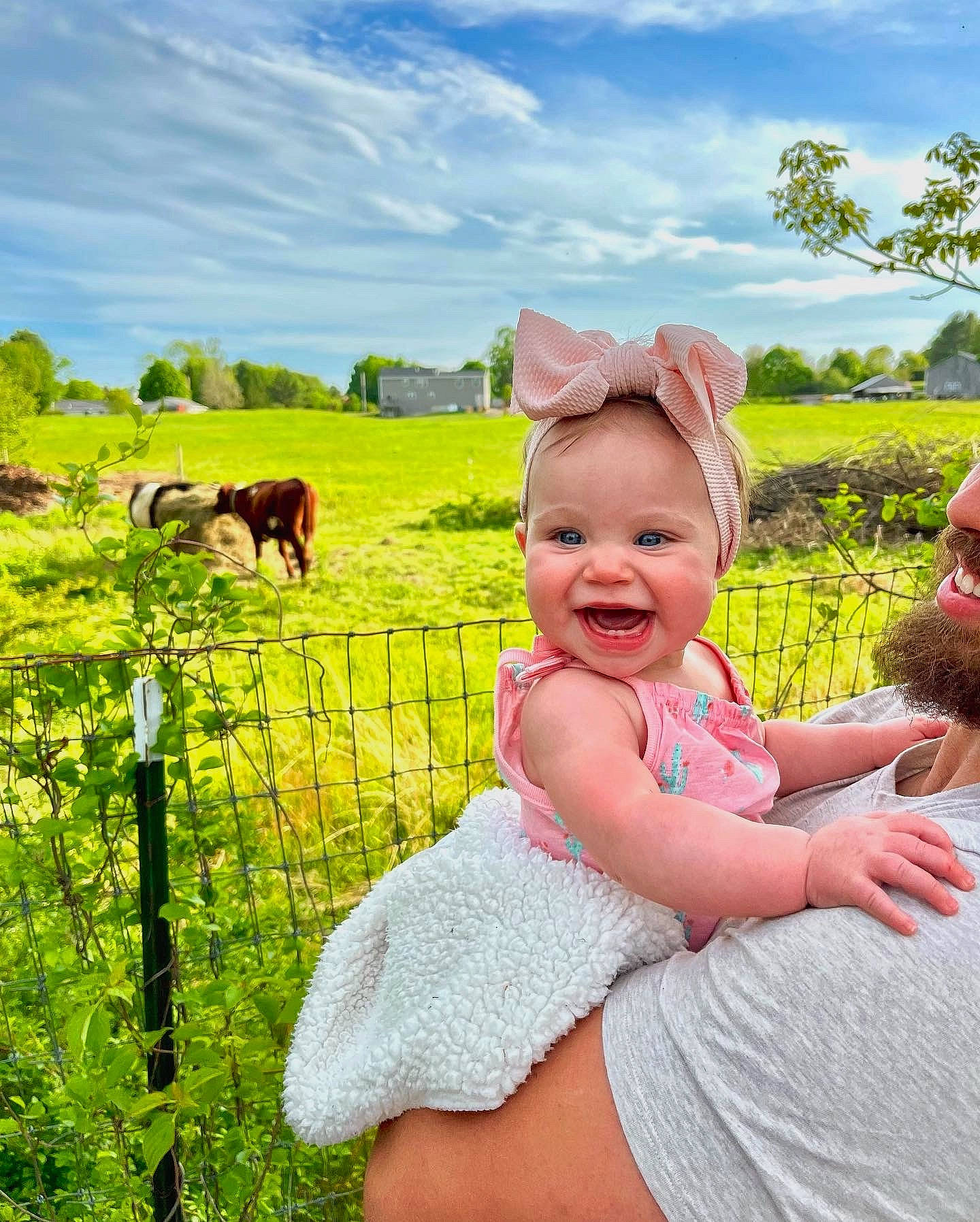 Charleigh is registered to the contest to win money with this photo: baby, baby_toddler_clothing, cloud, dress, fence, grass, grassland, green, happy, landscape, leisure, mammal, meadow, people_in_nature, person, plant, sky, smile, summer, toddler