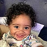 Zamir joined the competition — help win amazing prizes! baby, child, toddler, smiling, happy, portrait, selfie, curly_hair, brown_eyes, toothy_smile, indoors, bedroom, bed, pillow, blanket, pajamas, cartoon_pattern, close_up, cozy, photography