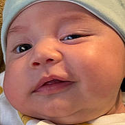 Aaron is registered to the contest to win money with this photo: baby, closeup, face, hat, cute, child, infant, skin, cheeks, expression, headwear, adorable, portrait, young, eyes, mouth, clothing, soft, person, indoors