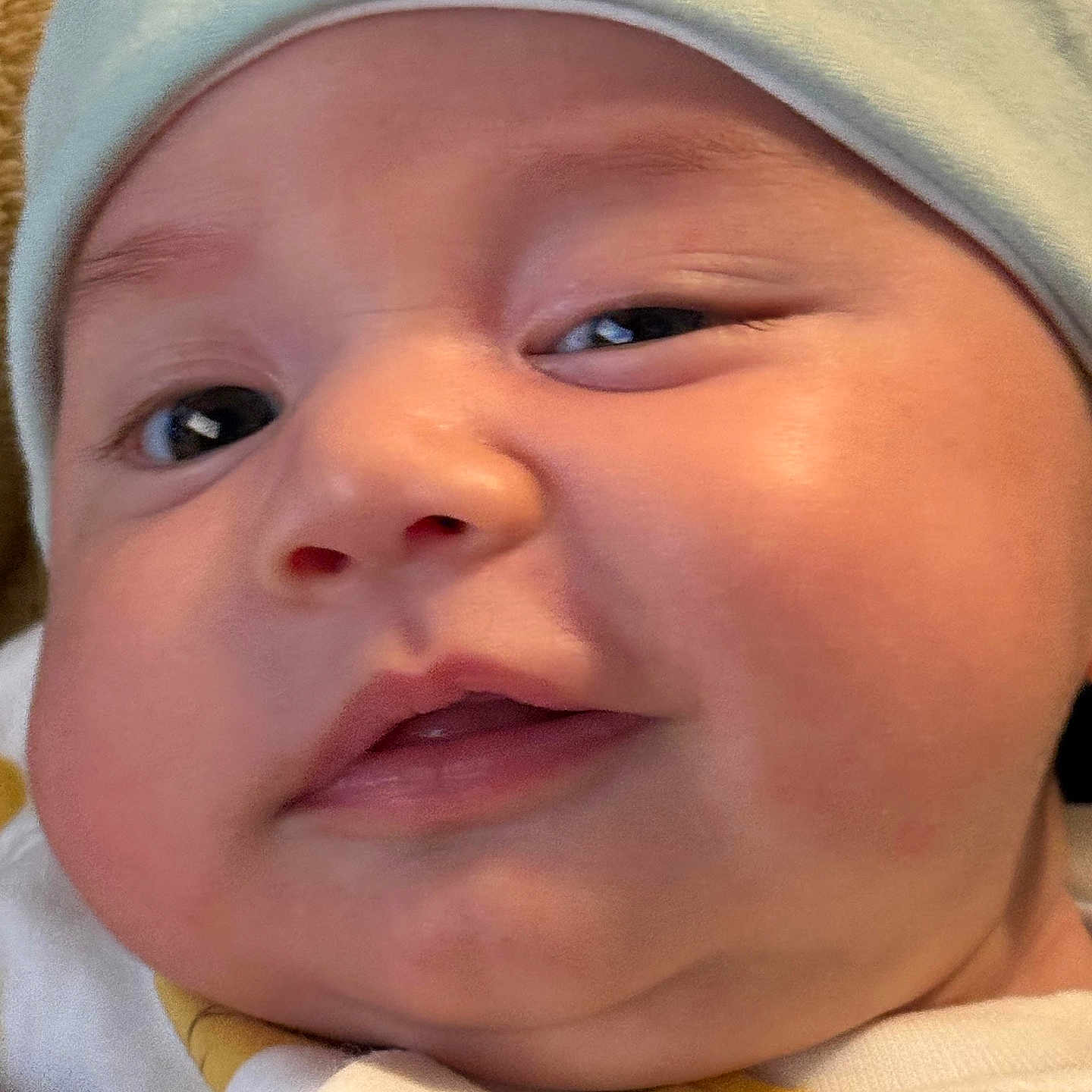 Aaron is registered to the contest to win money with this photo: baby, closeup, face, hat, cute, child, infant, skin, cheeks, expression, headwear, adorable, portrait, young, eyes, mouth, clothing, soft, person, indoors