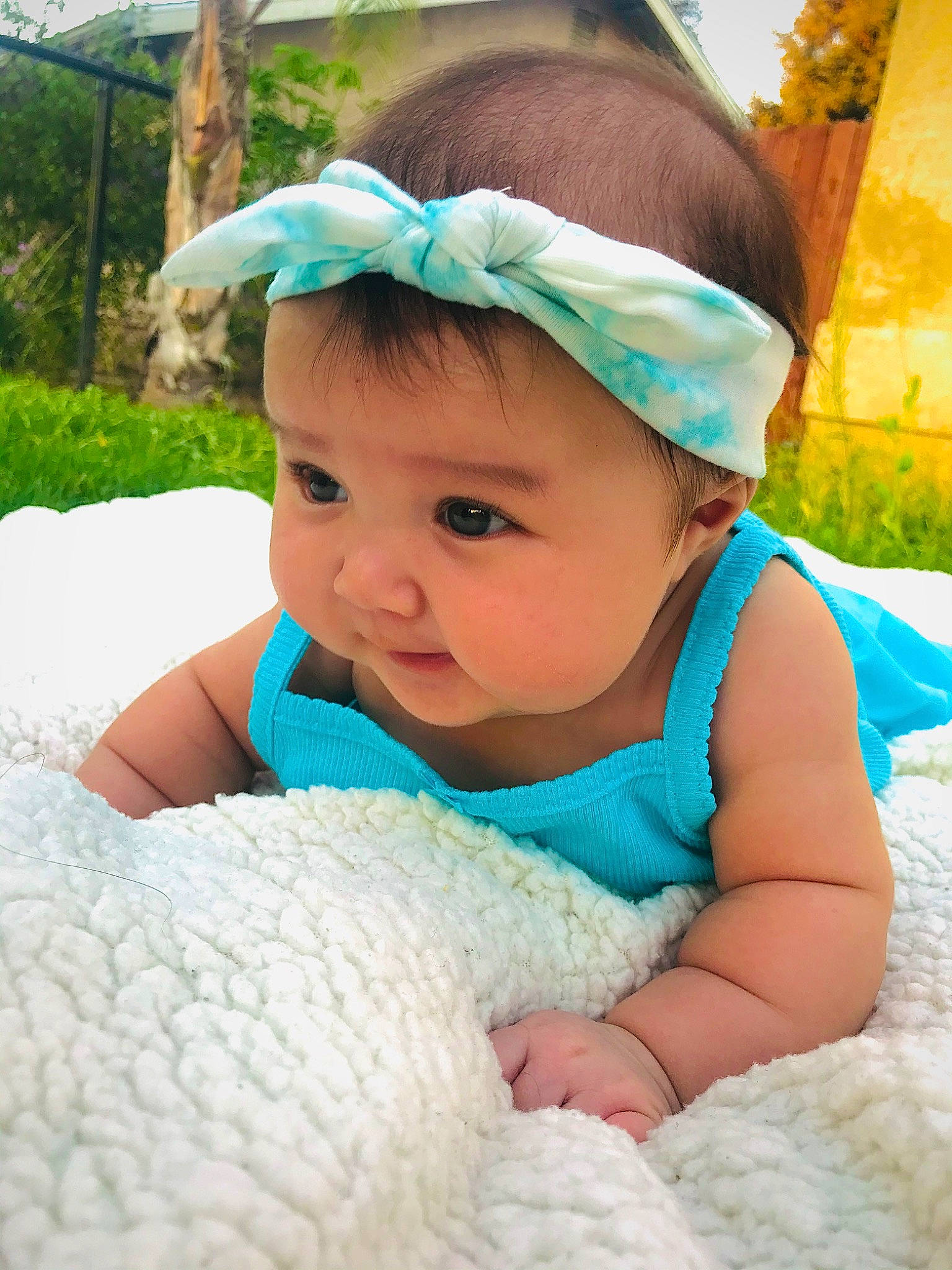Celeste is registered to the contest to win money with this photo: baby, baby_toddler_clothing, beauty, bonnet, child, dress, eye, face, fashion_accessory, grass, green, hair_accessory, happy, head, headgear, person, skin, smile, toddler, turquoise